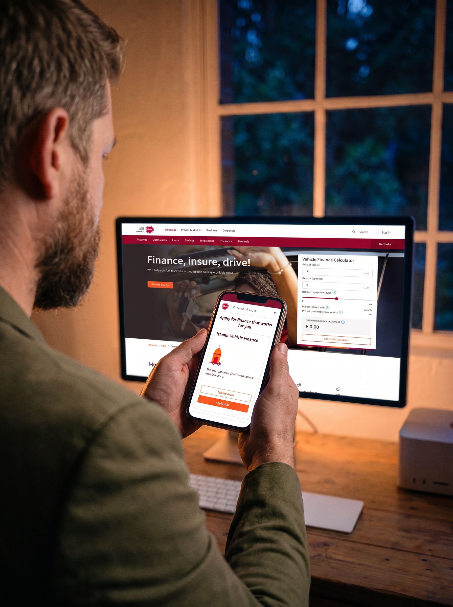 Seen over the shoulder of a bearded man at his desk at dusk, holding a phone showing Absa’s vehicle finance page on mobile, headed Apply for finance that works for you with an Islamic Vehicle Finance card. On the large display behind him, the same page at desktop width, headed Finance, insure, drive!, with a vehicle finance calculator beside it.