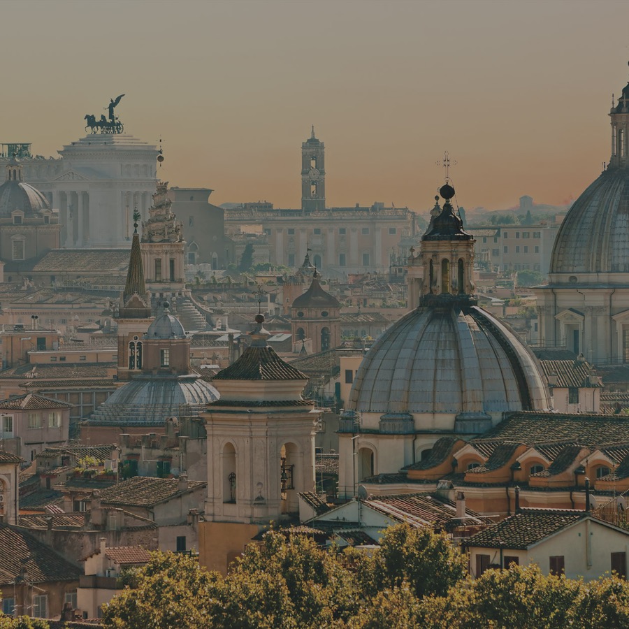 The rooftops and domes of Rome at golden hour, one of the seven regions the site sells.